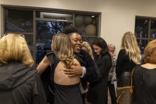 A group of Elase employees embracing