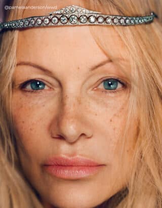 Image: Pamela Anderson captured in a close-up shot, radiating confidence sans makeup, highlighting her timeless elegance.