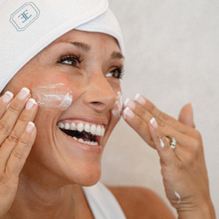 Woman putting on skincare products