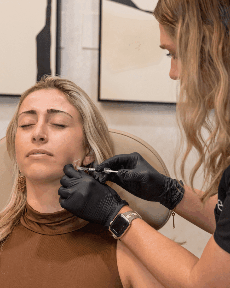 Provider administering Masseter Botox injection into a client’s jawline using precise technique, demonstrating treatment for jawline slimming and TMJ relief at Elase Med Spa.