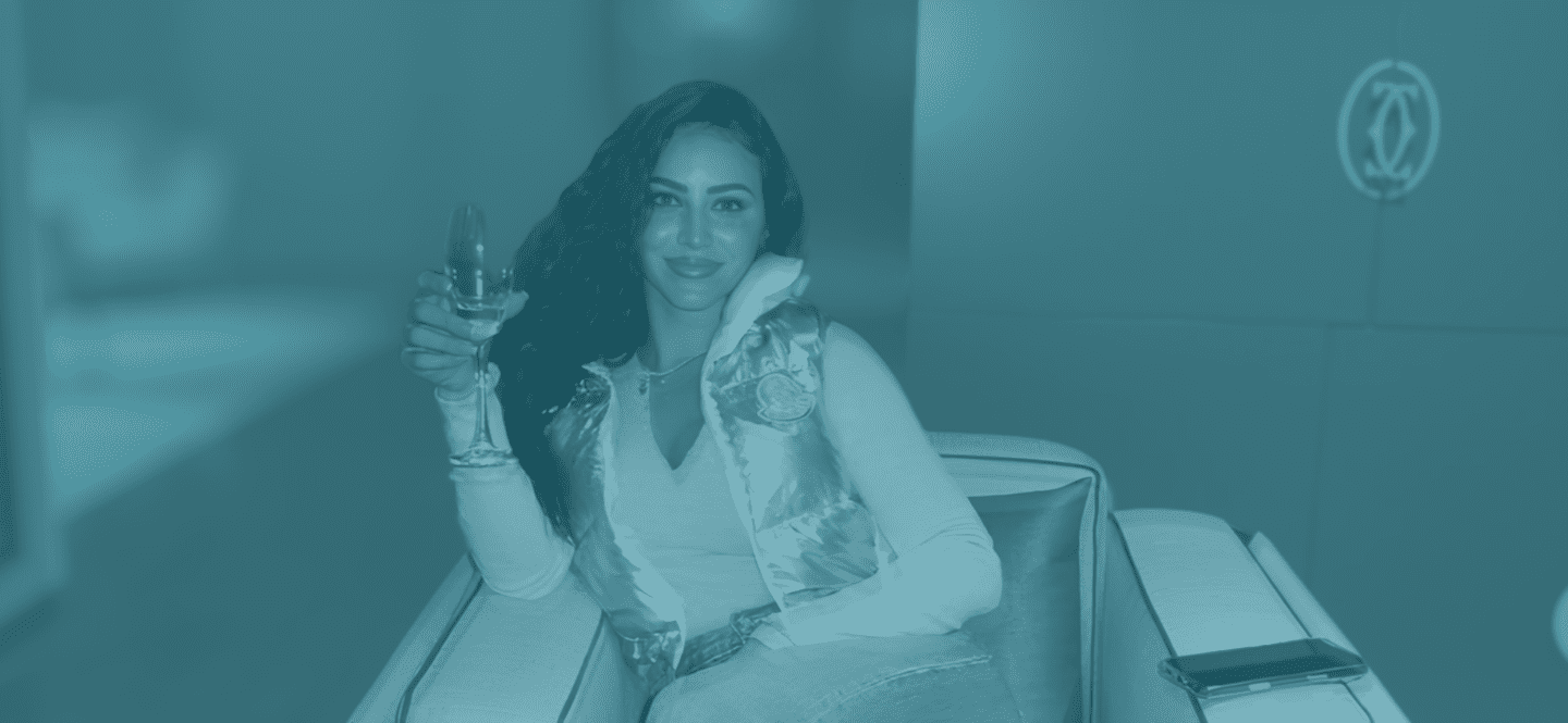 Elase client relaxing with champagne after lip filler dissolving and re-treatment, ready for her travel season.