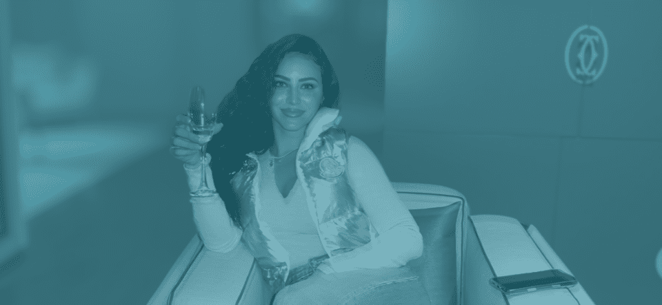 Elase client relaxing with champagne after lip filler dissolving and re-treatment, ready for her travel season.