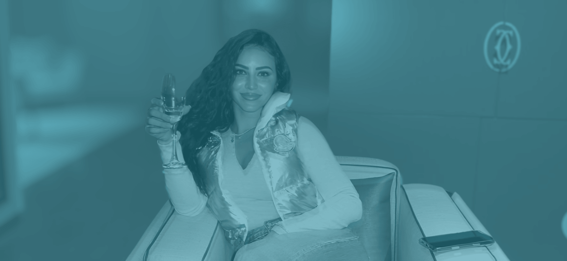 Elase client relaxing with champagne after lip filler dissolving and re-treatment, ready for her travel season.